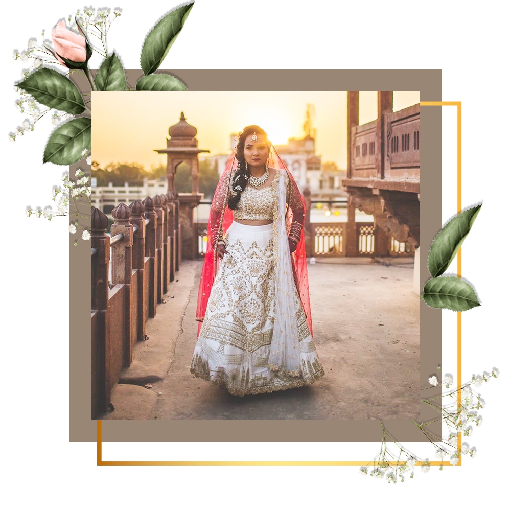 Bride in white Lehenga and pink dupatta