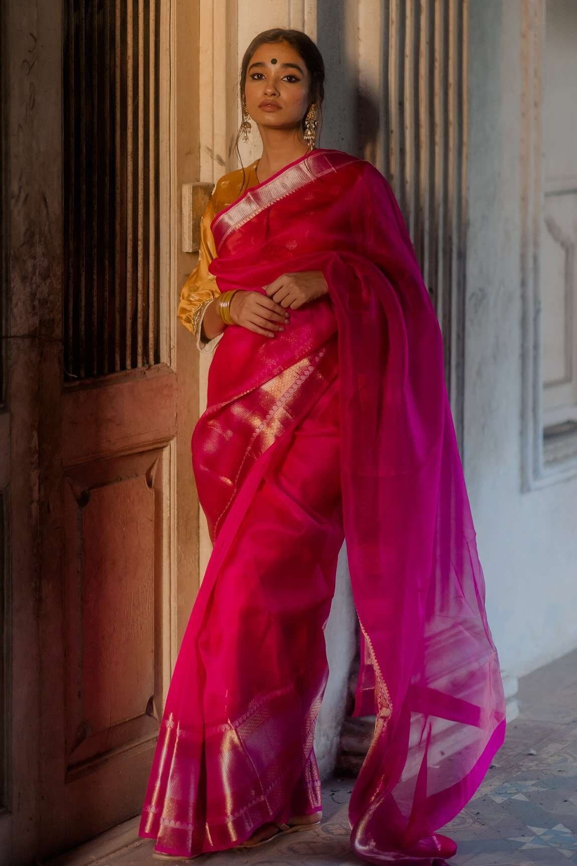 Ethnic Barbiecore pink silk saree from Mimamsaa with saffron blouse