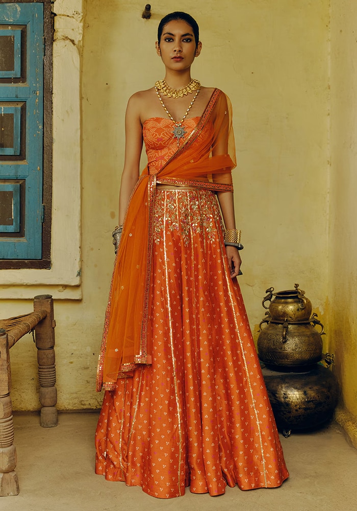 Orange lehenga by Drishti & Zahabia